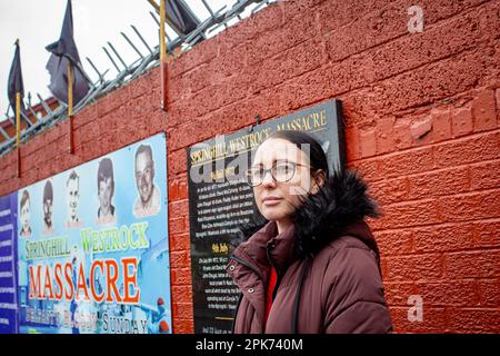 Natasha Butler granddaughter of Paddy Butler who was killed during the Springhill Westrock killings in front of the mural commemorating . Stock Photo