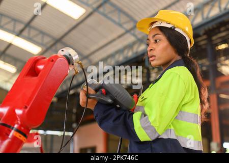 Professional female mechanical engineer worker in yellow hard hat Stock Photo