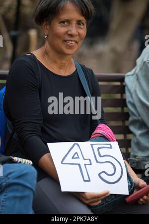 Woman shows handmade number 45 sign in support of President Trump during his historic arraignment, Manhattan Criminal Court House, NYC. 04 April 2023. Stock Photo