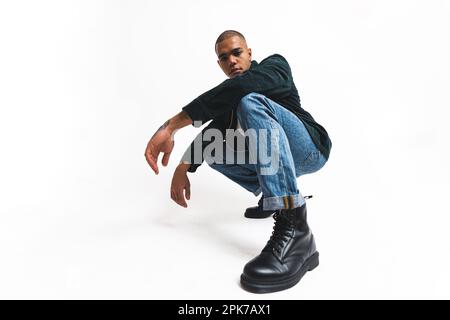 Young Male Dancer Standing In A Crouch Pose With His Arms Opened, Welcoming  You Stock Photo, Picture and Royalty Free Image. Image 18025388.