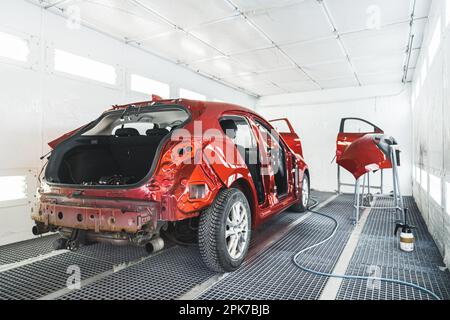 a car and its parts after painting in paint shop, full shot, repair after an accident. High quality photo Stock Photo
