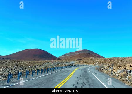 Road to Mauna Kea, winding through the scenic terrain of Hawaii's highest volcano. Stock Photo