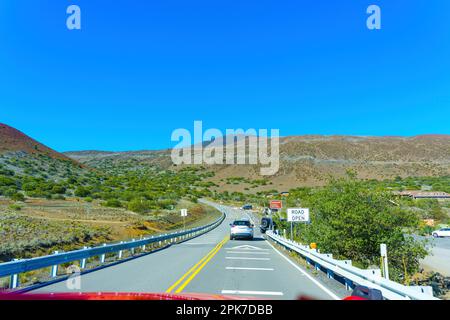 Majestic Mauna Kea landscape with the winding road and the exit to the visitors station. Stock Photo