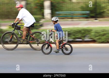 MERIDA, MEXICO - OCTOBER 23, 2016 Sunday cycling on the  Paseo de Montejo - father and son Stock Photo