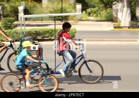 MERIDA, MEXICO - OCTOBER 23, 2016 Sunday cycling on the  Paseo de Montejo - tricycle with roof Stock Photo