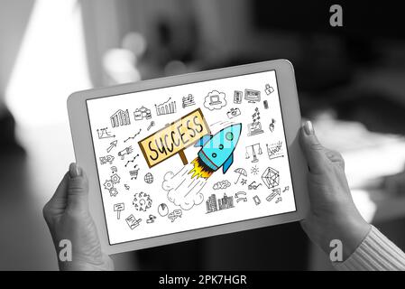 Business success concept shown on a tablet held by a woman Stock Photo