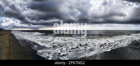 Panoramic view of bad weather and threatening sky on the Roman coast with rough and foamy sea. Stock Photo