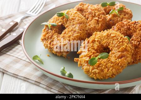 Homemade fried chicken donuts or big nuggets close-up on a plate on the table. Horizontal Stock Photo