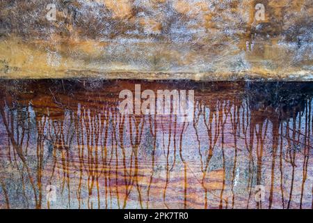 Dripping paint rivulets on repaired fiberglass, mottled and striped colours. Stock Photo