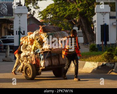 Stone Town, Tanzania - Jan, 2021: Transportation of goods. Daily live in the African village on the tropical island of Zanzibar. Africa. Stock Photo