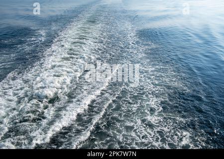 The wake from a ferry boat, foam and ripples on the ocean. Stock Photo