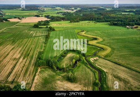 An aerial view of the vast rolling hills of rural farmland with lush green vegetation Stock Photo