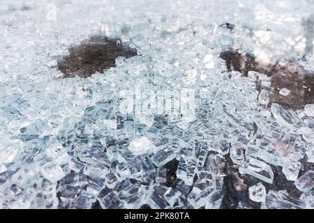 Macro of safety glass shards lying on the ground. Stock Photo