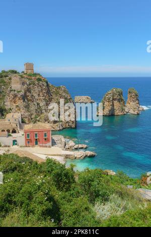 view of Tonnara di Scopello during summer. Beautiful landscape of Sicily, Italy, Europe. Calm morning seascape of Mediterranean sea. Stock Photo