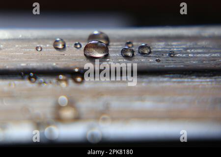 Hydrophobic surface of impregnated wood with water drops. Stock Photo