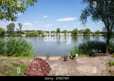 Picture of the panorama of lake tresetiste in Subotica, Serbia, during a warm summer afternoon, with fishing rods used by fishermen Stock Photo