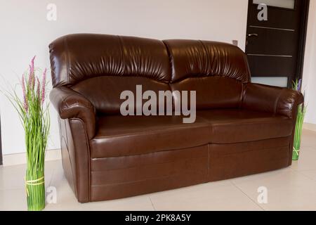 Leather brown sofa in the living room. Stock Photo