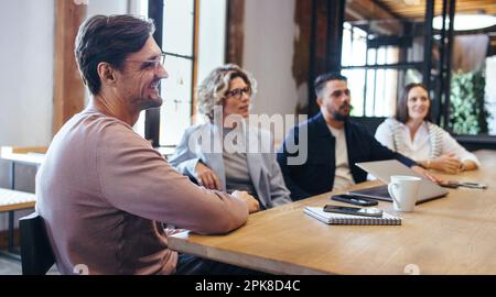 Professional business people having a meeting in a boardroom. Group of business people having a discussion during a conference. Team of professionals Stock Photo