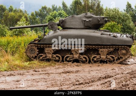 An American World War II Sherman M41A1 76 (w) tank stands in a field in the mud. Bielsko-Biała, Poland Stock Photo