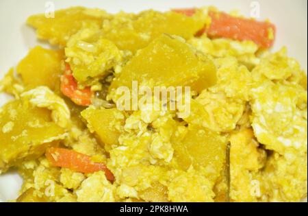 stir fried pumpkin with egg on plate in white background Stock Photo