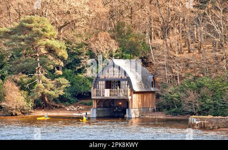 Aldourie Castle Estate Loch Ness Scotland the elaborate boat house seen from the Loch and two yellow kayaks Stock Photo