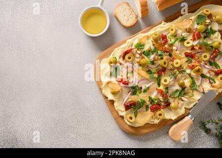 Homemade trendy Butterboard with onion, garlic, herbs, crispy baguette on gray background. Copy space. View from above. Stock Photo