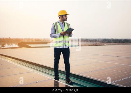 Engineer foreman using tablet checking at industrial solar power plant Stock Photo