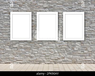 Three white blank frame templates on a decorative stone wall. Stock Photo