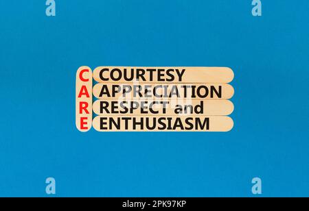 CARE symbol. Concept words CARE courtesy appreciation respect and enthusiasm on wooden stick on beautiful blue background. Business CARE courtesy appr Stock Photo