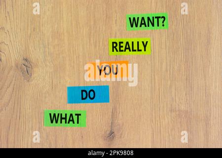 What do you really want symbol. Concept words What do you really want on colored paper. Beautiful wooden table wooden background. Business and what do Stock Photo