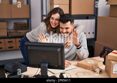 Man and woman ecommerce business workers having video call at office Stock Photo