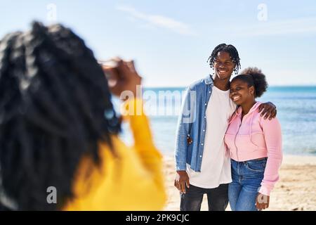 African american friends hugging each other making photo at seaside Stock Photo