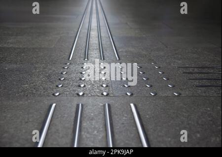 Floor tiles with tactile ground surface indicators, closeup view Stock Photo