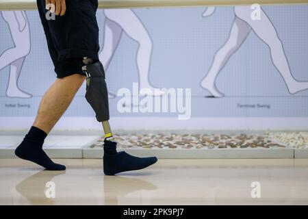 Athlete man with prosthetic leg walking at health care center Stock Photo