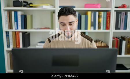 Young arab man student using computer studying at university classroom Stock Photo