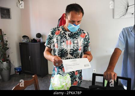 Liberal country nurse at the home of a patient for subcutaneous injection of Lovenox for the prevention of phlebitis. Stock Photo