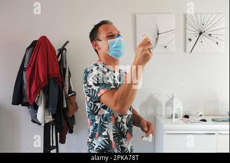 Liberal country nurse at the home of a patient for subcutaneous injection of Lovenox for the prevention of phlebitis. Stock Photo