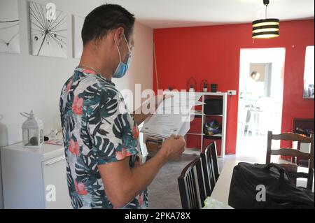 Liberal country nurse at the home of a patient for subcutaneous injection of Lovenox for the prevention of phlebitis. Stock Photo