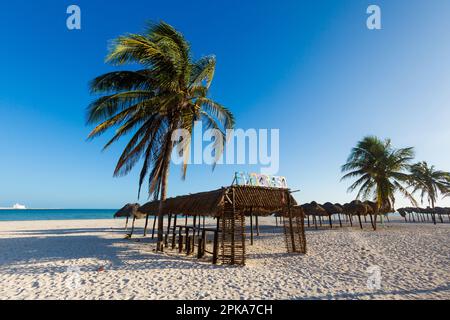 Beautiful Progreso beach in Mexico during sunny day. White beach with palms and blue sky. Stock Photo