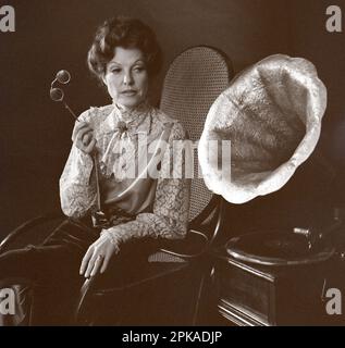 12.10.1985, German Democratic Republic, , Berlin - Woman with lorgnette listening to her gramophone. 00S851012D119CAROEX.JPG [MODEL RELEASE: NO, PROPE Stock Photo