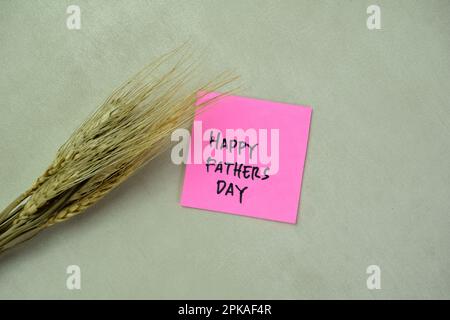 Concept of Happy Fathers Day write on sticky notes isolated on Wooden Table. Stock Photo