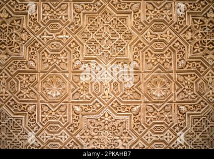 Nasrid Kufic poetic inscriptions in relief on the walls of the Alhambra in Granada, Spain Stock Photo