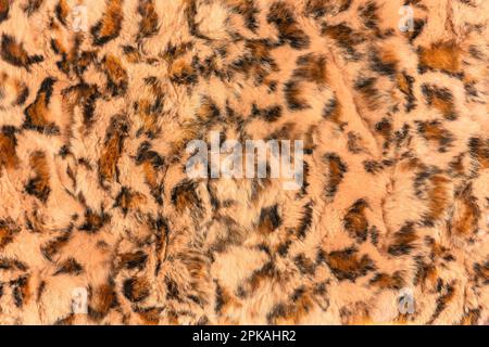 A synthetic material resembling long animal hair has been used to create a highly intricate background texture that mimics the appearance of leopard f Stock Photo