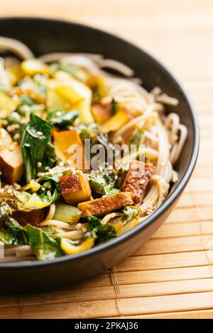 Bok Choi Stir-Fry with Smoked Tofu on buckwheat noodles. Stock Photo