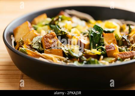 Bok Choi Stir-Fry with Smoked Tofu on buckwheat noodles. Stock Photo