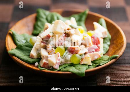 Traditional Waldorf salad with a vegan dressing on New Zealand spinach. Stock Photo