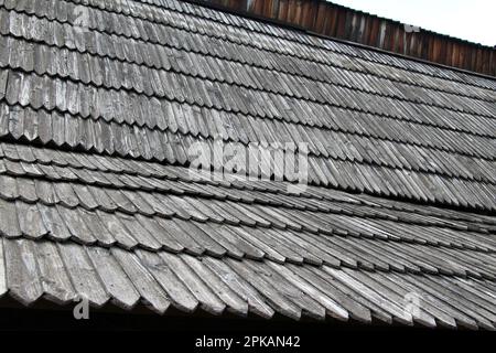 The roof of the old building is covered with wooden tiles Stock Photo