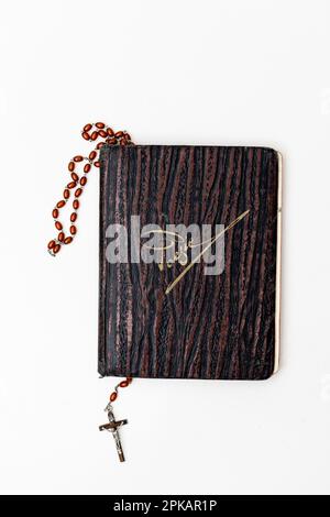 Old poetry album with a rosary between the pages of the book Stock Photo