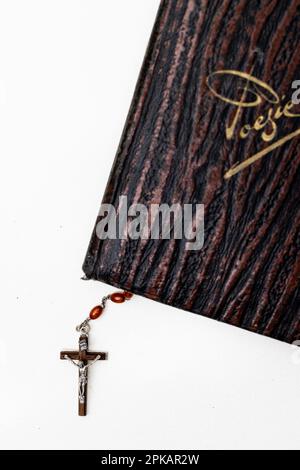 Old poetry album with a rosary between the pages of the book Stock Photo