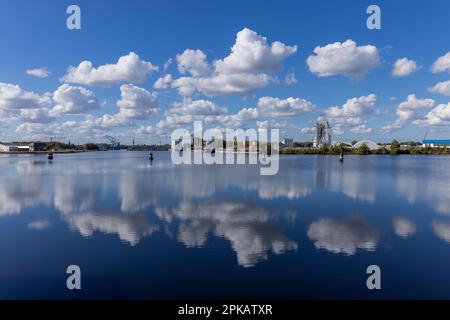 View from the lock road to the equipment harbor, clouds reflected in the water, Wilhelmshaven, Lower Saxony, Germany Stock Photo